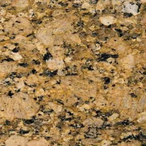 Gros plan sur la texture du granit Giallo Veneziano, composé de cristaux dorés, beiges, noirs et gris formant un motif minéral chaleureux.