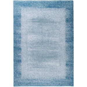 pure-tone-tapis-acoustique-bleu-interieur-salon Vue complète du tapis acoustique Pure Tone bleu, avec un centre bleu clair légèrement chiné entouré d’une bordure bleu plus soutenu.